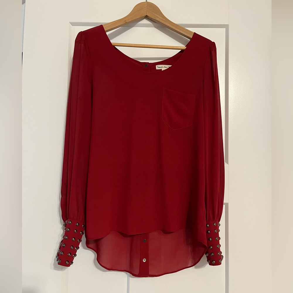 Sheer Blouse with studded cuffs and snaps down the back.